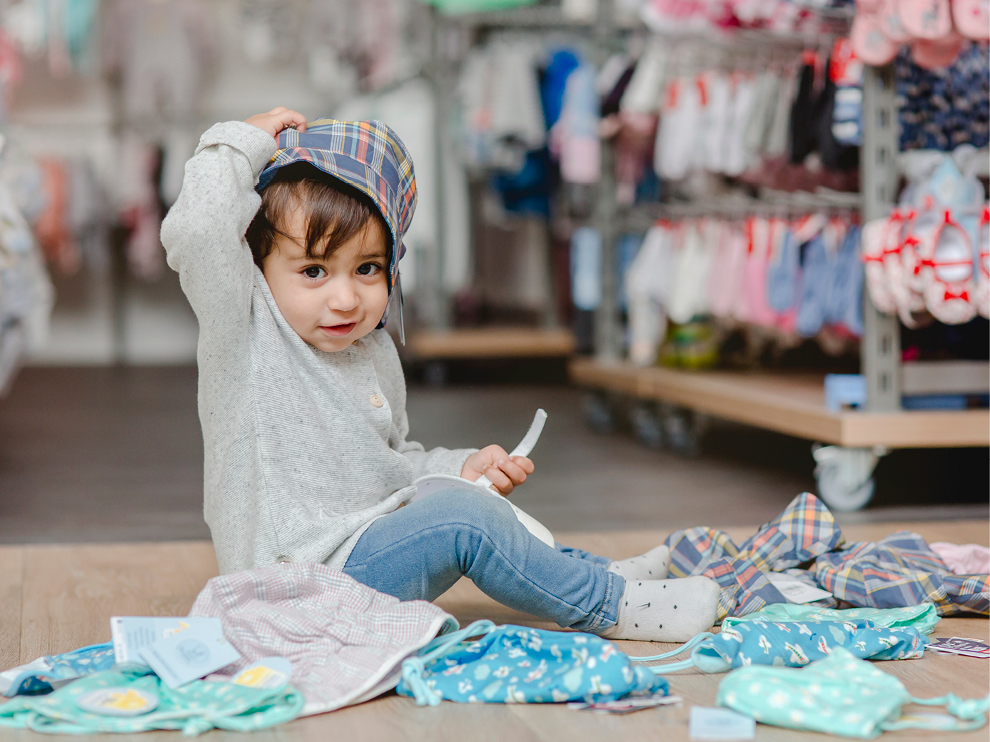 Ein mädchen kleines, das auf dem boden vor einem haufen.